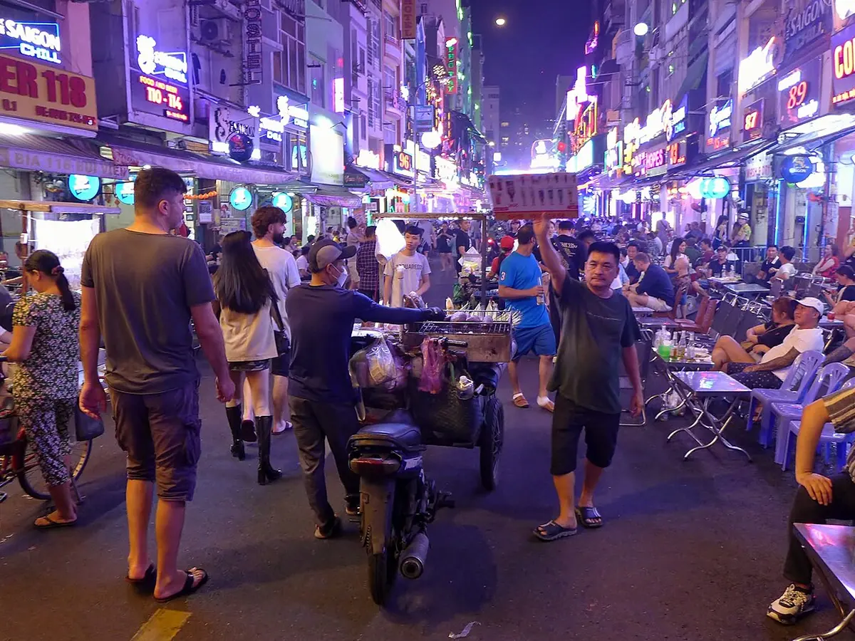 Bui Vien Street at night with neon signs and crowds