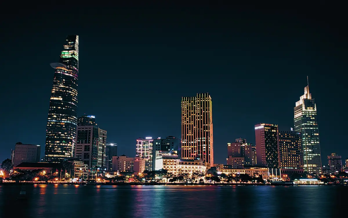 District 1, Ho Chi Minh City, at night seen across the Saigon River, with Bitexco Tower on the left